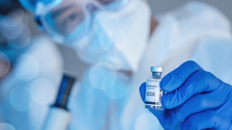 doctor holding a vaccine vial