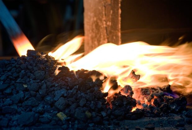 a pile of coals on fire with glowing hot metal